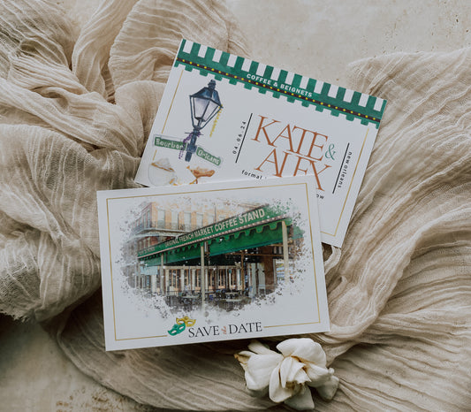 New Orleans save the date featuring a watercolor image of Cafe du Monde with Mardi Gras masks, beignets, cafe au lait and a street lamp.