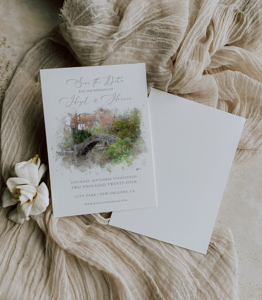 New Orleans City Park watercolor save the date featuring the popular wedding spot, Langles Bridge, with a script and serif grey font.