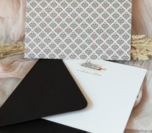 New Orleans notecard with a watercolor image of the Creole Queen on front and the words "a note from Nola."  The back has a black/white/red damask pattern.