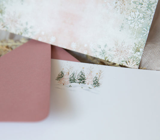 Double sided notecard set featuring forest green and light pink Christmas trees on the front and a sage green and light pink snowflake pattern on the back with mauve envelopes.