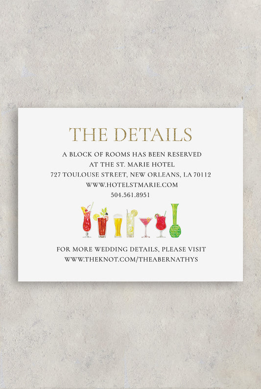 Fun watercolor drink wedding details card with a hurricane drink, Hand Grenade drink, bloody mary drink and tom collins drink.  Wedding accommodations and hotel block information for wedding guests are also listed as well as the wedding website.