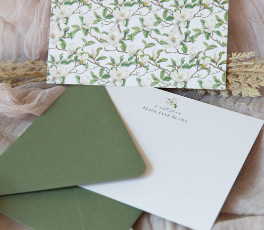 Southern notecard with a watercolor magnolia on the front and personalized with "a note from" and your name. Beautiful branches and magnolia blooms cover the back. Comes with sage green envelopes.