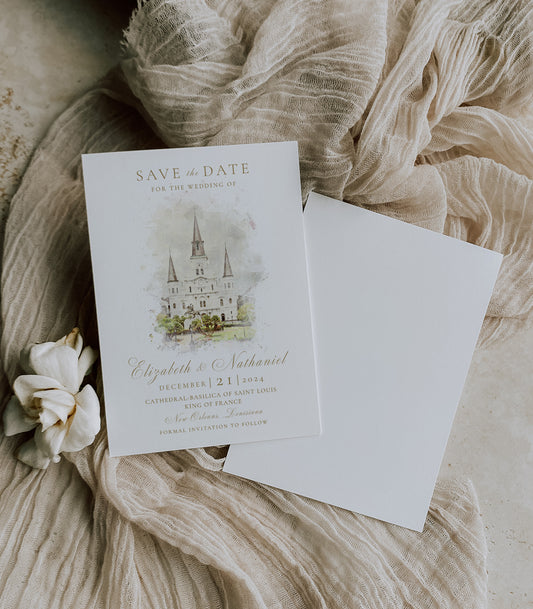 New Orleans wedding save the date featuring a watercolor image of the St. Louis Cathedral in Jackson Square with your personalized wedding details written in a gold script font.