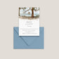 Fontainebleau State Park wedding RSVP card with the beautiful park pier out over of the water of Lake Pontchartrain, beach scene and trees, layered over a dusty blue envelope on a light beige background.