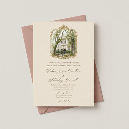 An elegant wedding invitation card with a vintage-style illustration of the House of Broel mansion under an ornate gold frame, layered over a dusty rose envelope on a light beige background.