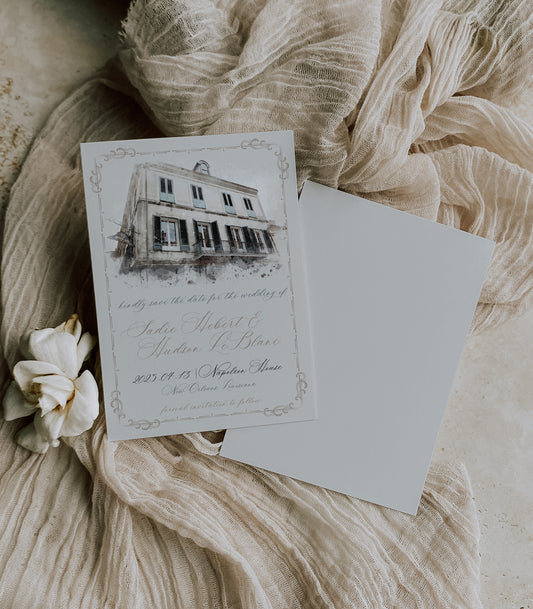 New Orleans save the date with a watercolor image of The Napoleon House in the French Quarter of New Orleans. Dainty swirls with blue and brown script writing complete the invitation.