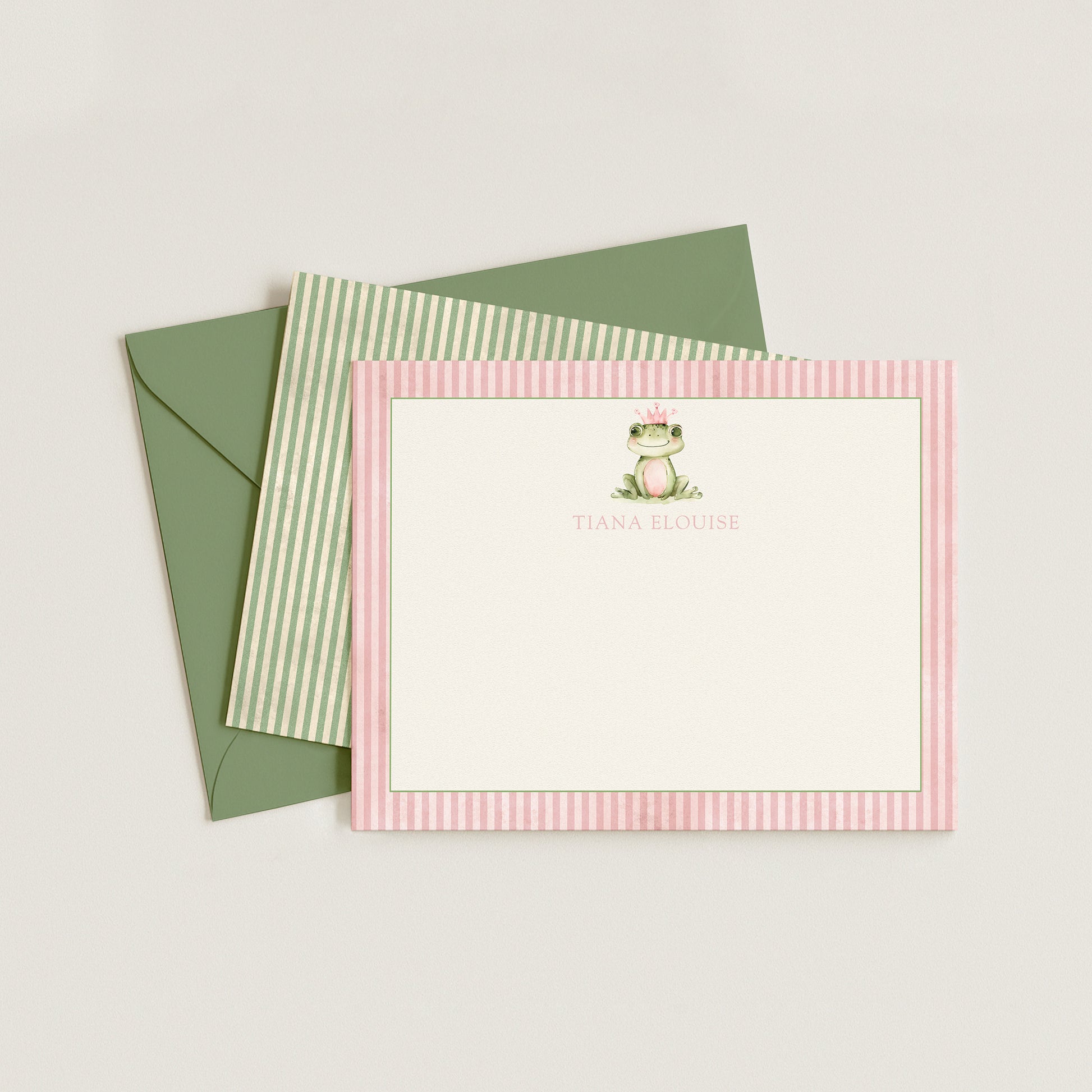 Note card with frog illustration and green envelope on light gray background